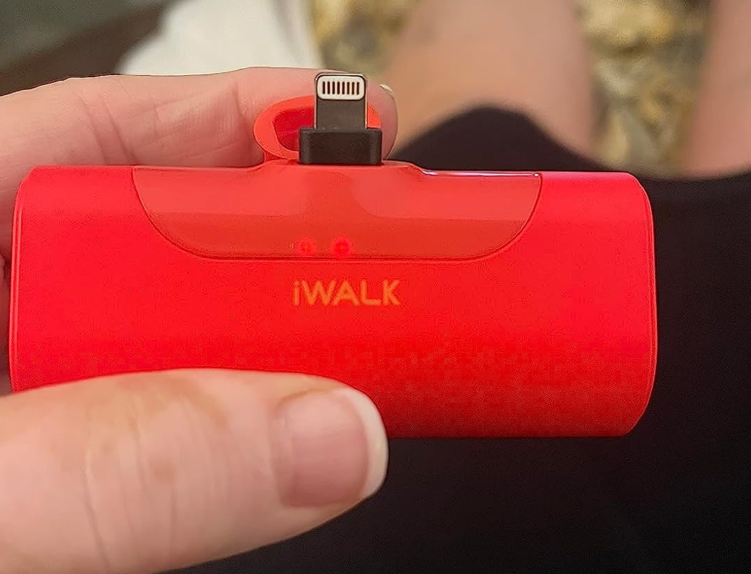 Reviewer holding the red portable charger 