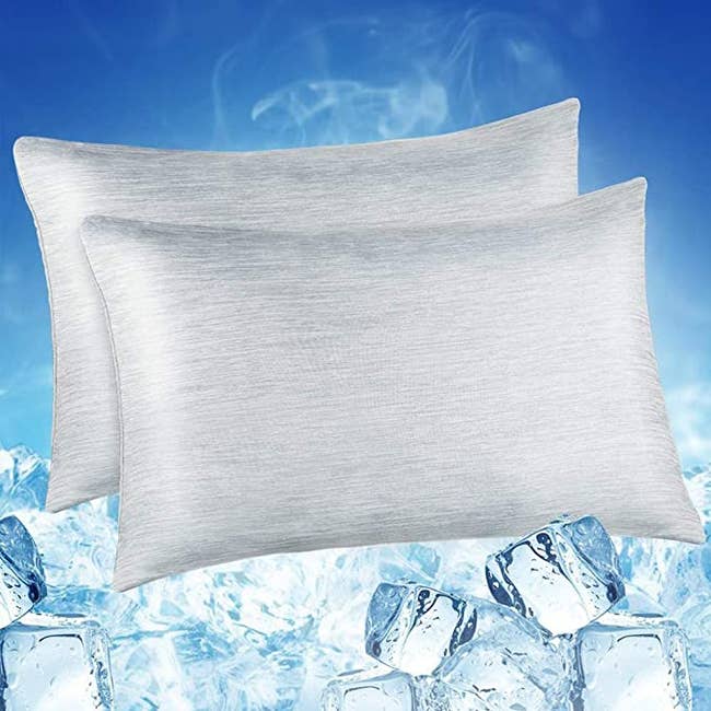 Two pillows in gray above an image of ice cubes