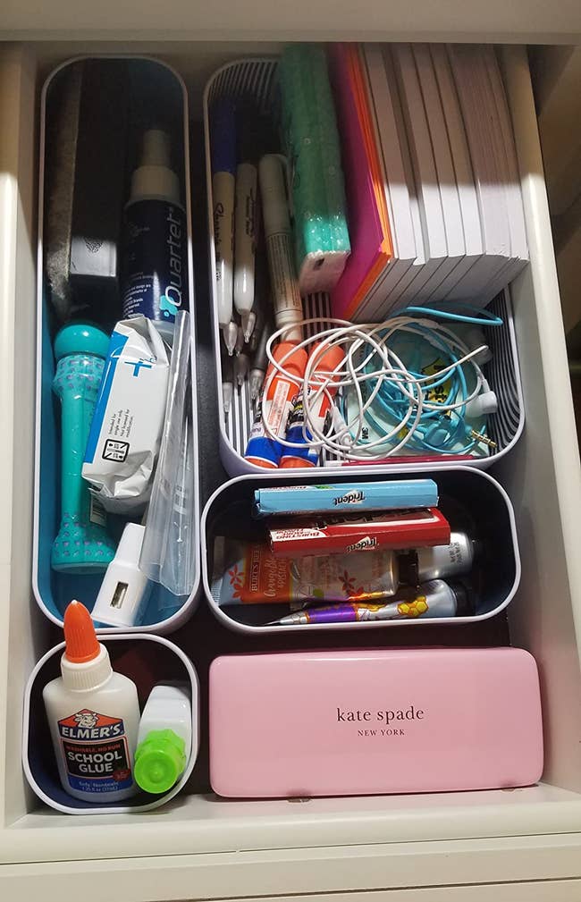 Reviewer using the organizers to hold their makeup and office supplies