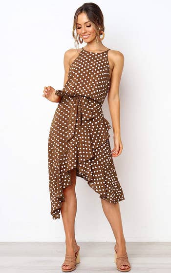 model wearing the halter dress in brown with white polka dots