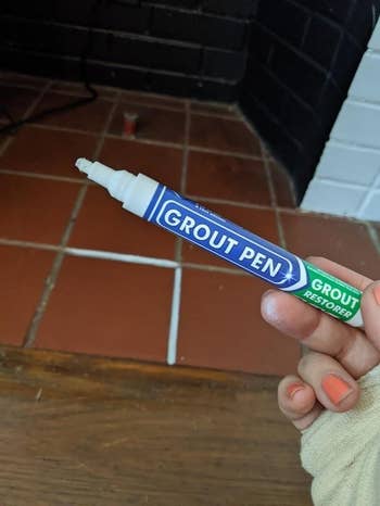 A customer review photo holding up the grout pen