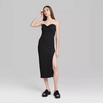 a straight size model wearing the black dress