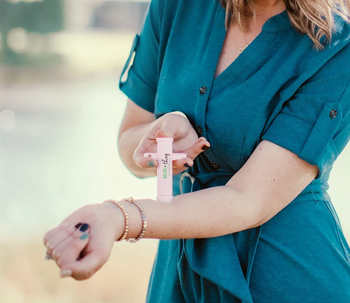 Model is using the bug bite tool on their forearm