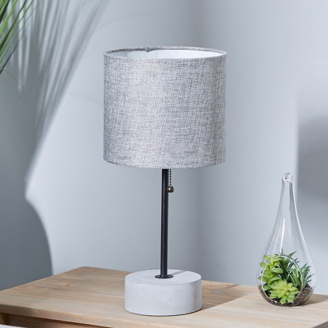 lamp with gray shade on a bedside table