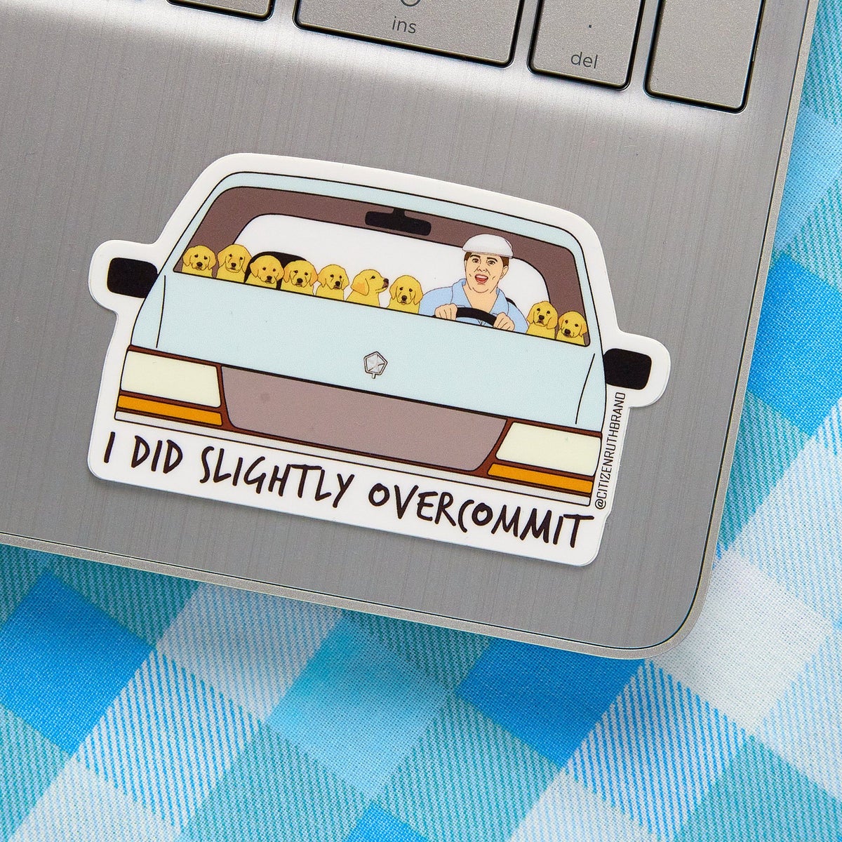 sticker of melissa mccarthy's bridesmaids character in a car with nine puppies and the text