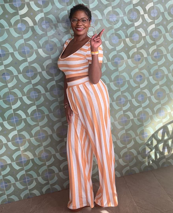 reviewer wearing the orange and white striped pants set