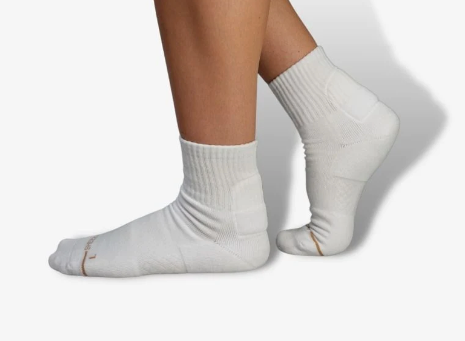 A model wearing the foam-padded socks