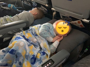 reviewer's photo of their children sleeping on the inflatable foot rests