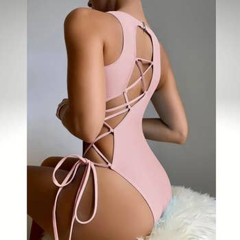 model showing side and back of swimsuit that laces up