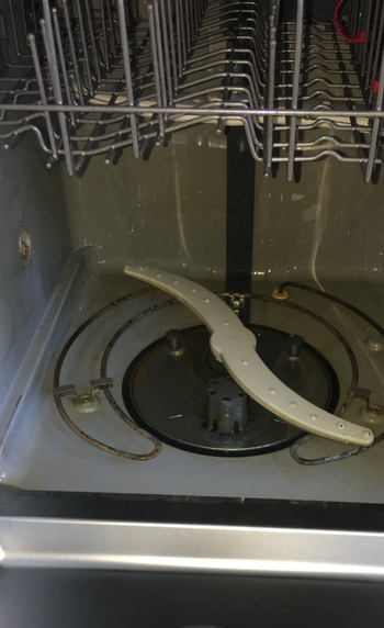 the same dishwasher now looking cleaner after using a tablet