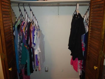 reviewer after image of clothes on the wonder hangers and lots of open closet space