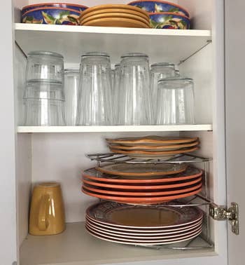reviewer's chrome organizer on a cabinet shelf holding plates
