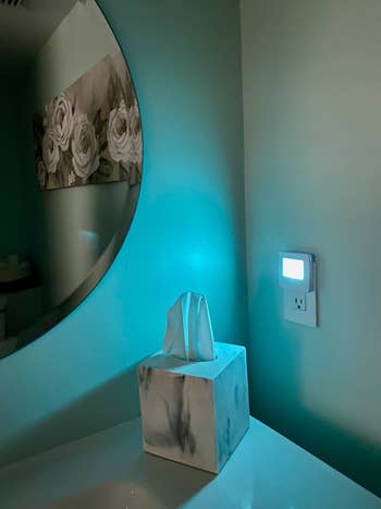 another reviewer photo of the night-light emitting a teal-colored light