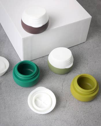 Small cosmetic containers with white lids