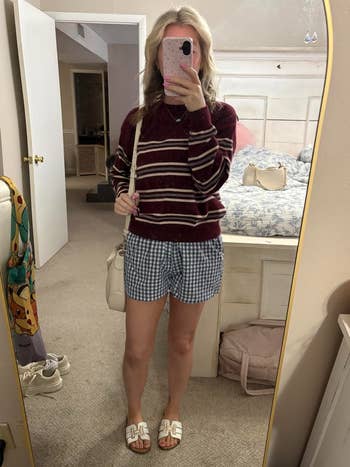 A reviewer wearing the shorts successful  beforehand   of a mirror