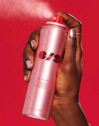 Hand holding a tin of mounting spray