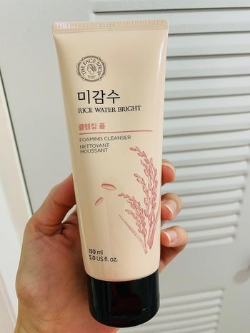 Reviewer holding the cleanser