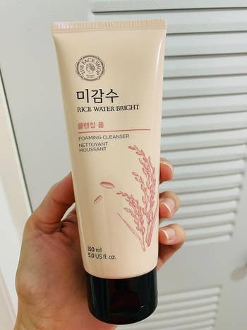 Reviewer holding the cleanser