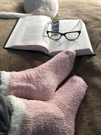 reviewer wearing pink and white fluffy socks