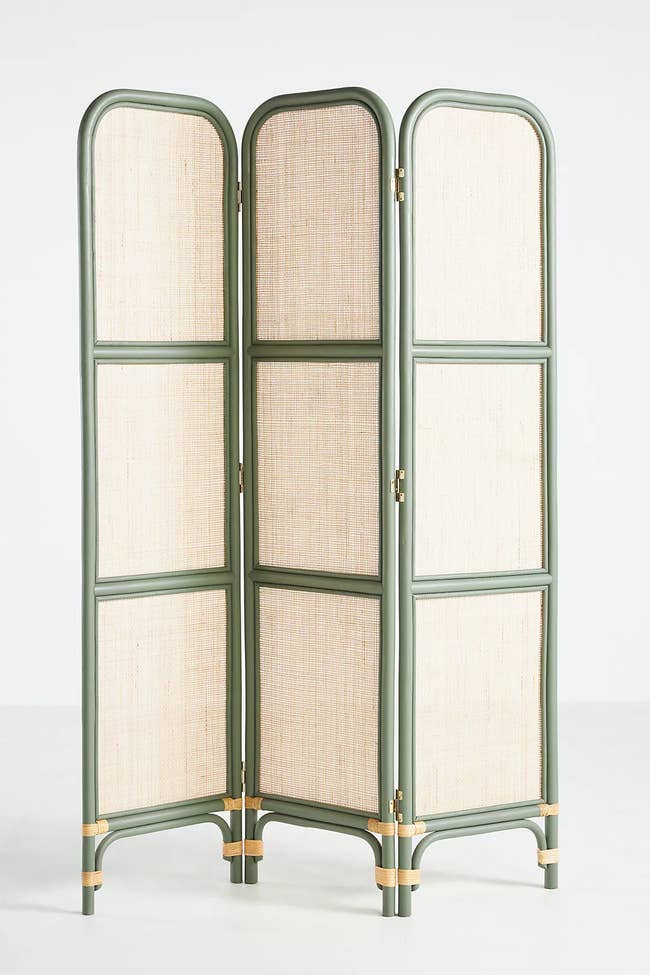 green and tan rattan room divider with three panels