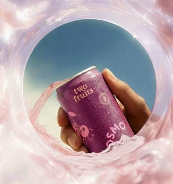 Hand holding a sparkling beverage tin  labeled 