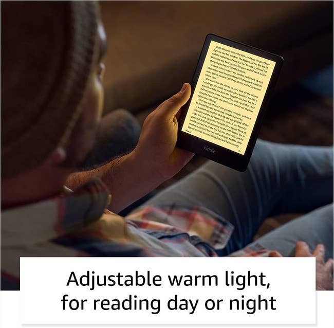 Person reading on a Kindle with adjustable warm light feature