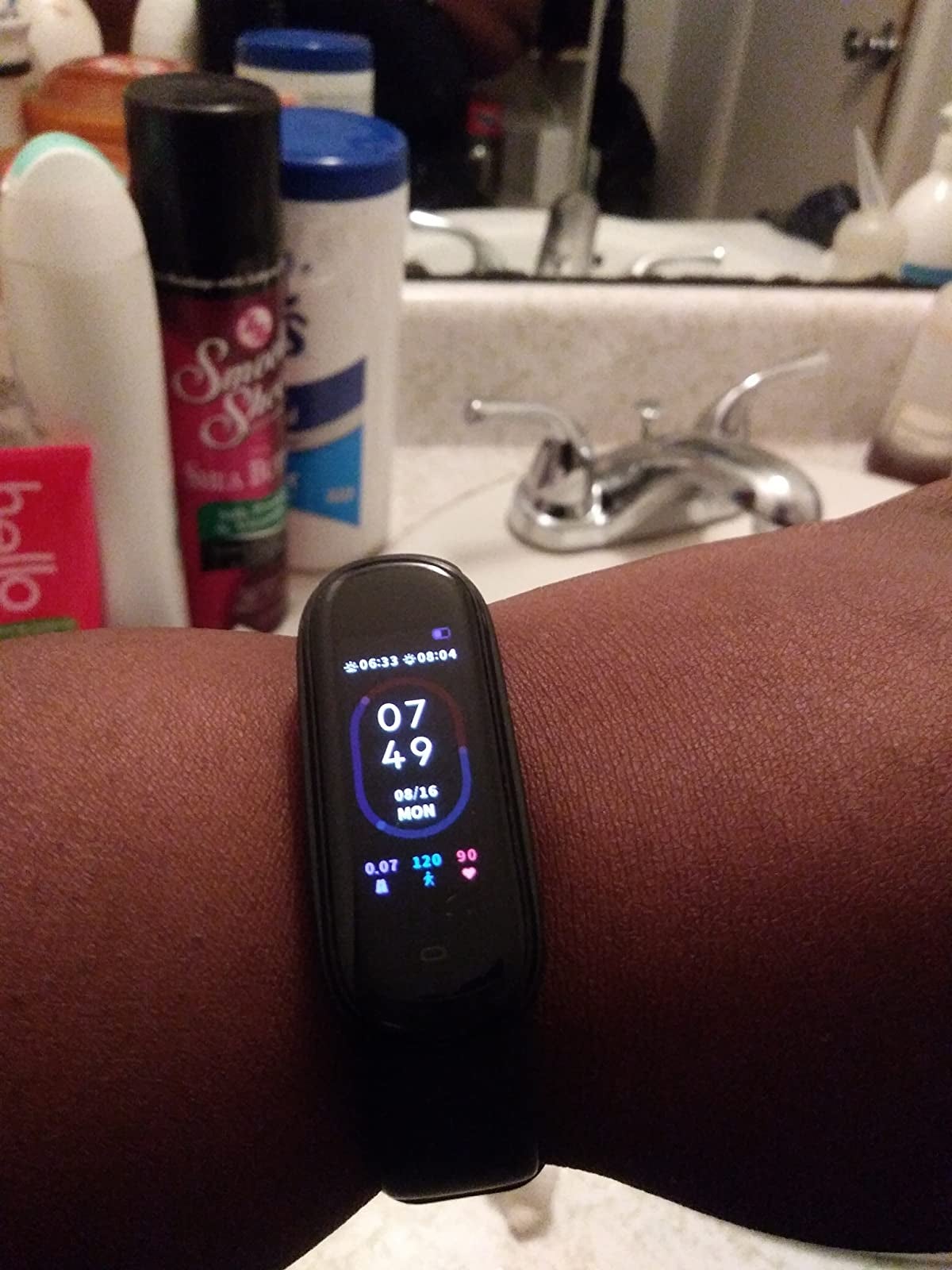 reviewer wears black fitness tracker with screen displaying blood oxygen level, steps, and mileage