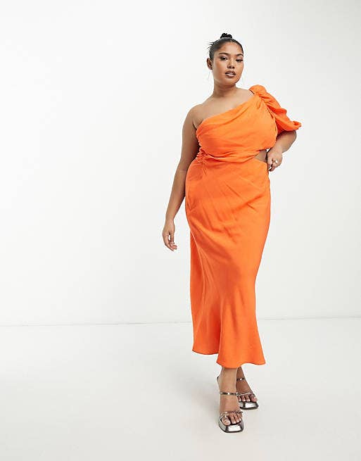 A model posing in the orange maxi dress