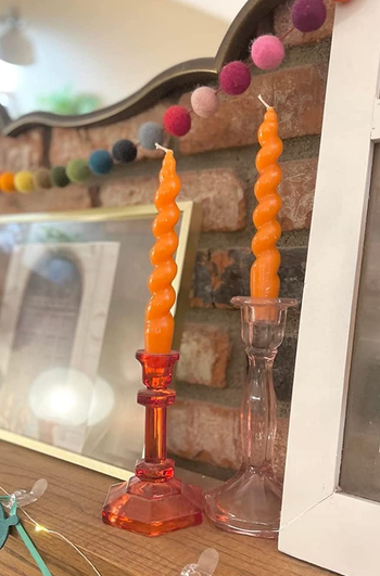 orange candles sitting on a mantel