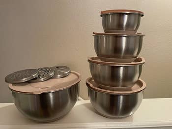 a reviewer's bowls with their lids and grater attachments stacked on top of each other