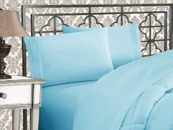 Pale bluish  bedding acceptable   connected  a bed