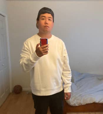reviewer wearing the sweater in white