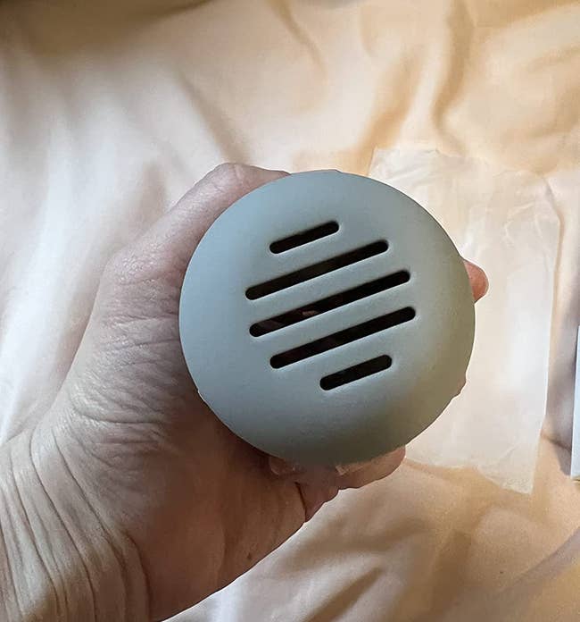 Reviewer photo of the makeup sponge holder in a light grey