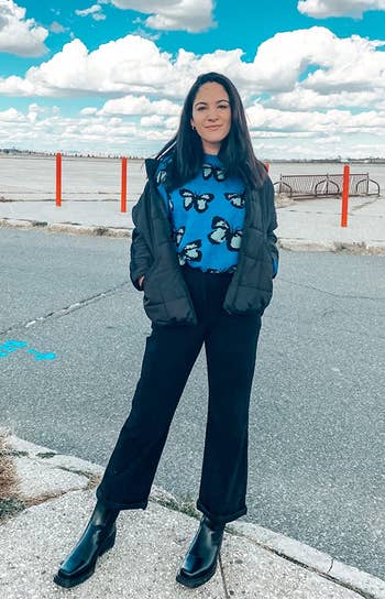 reviewer photo wearing black corduroy pants, posing in parking lot