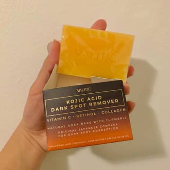 review holding Valtic Dark Spot Remover soap bar packaging