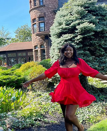 Reviewer wearing red mini dress