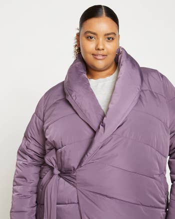 model wearing the coat in purple
