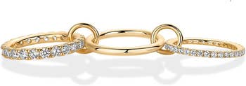 Four gold rings linked, two with embedded diamonds, suitable for elegant and stylish accessorizing