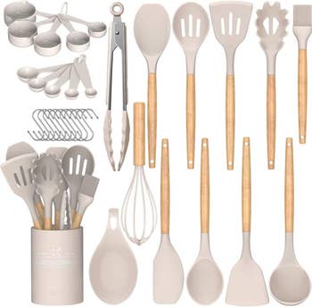Kitchen utensil acceptable with measuring spoons, silicone spatulas, whisk, tongs, and holder, perfect for modern cooking and baking needs