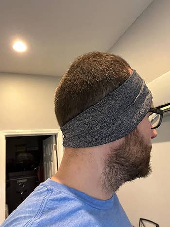 Reviewer showing side view while wearing the headband headphones