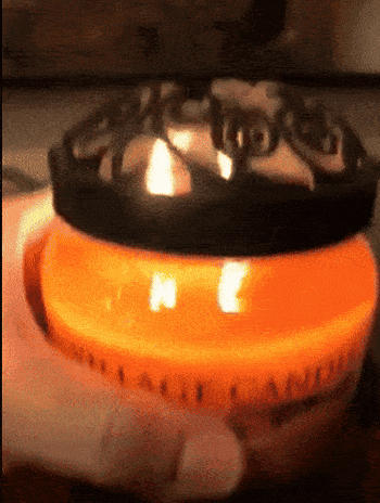 gif of reviewer holding up the lit candle