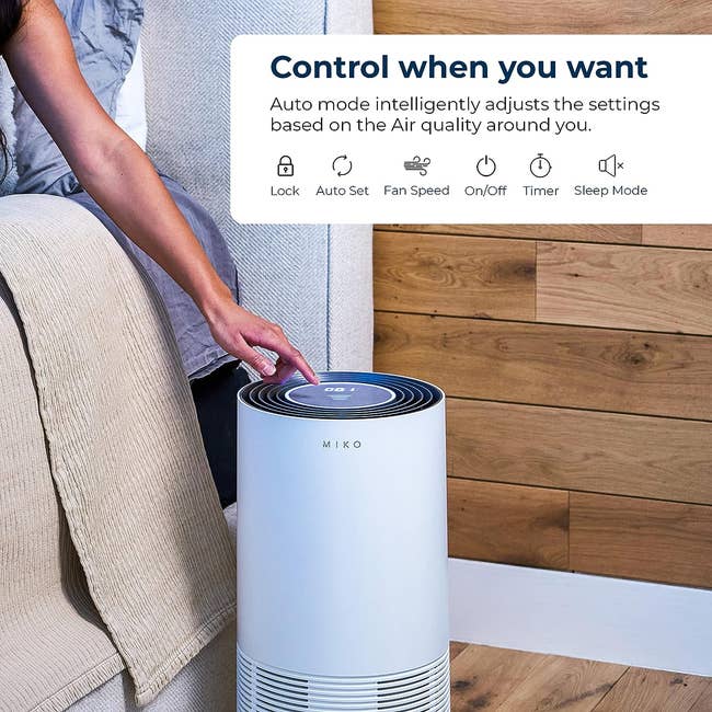 the air purifier beside a bed