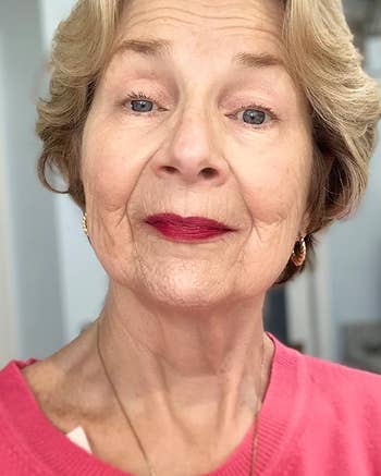 Older reviewer wearing ruby-colored lip stain