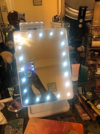 a reviewer photo of the mirror with the lights on 