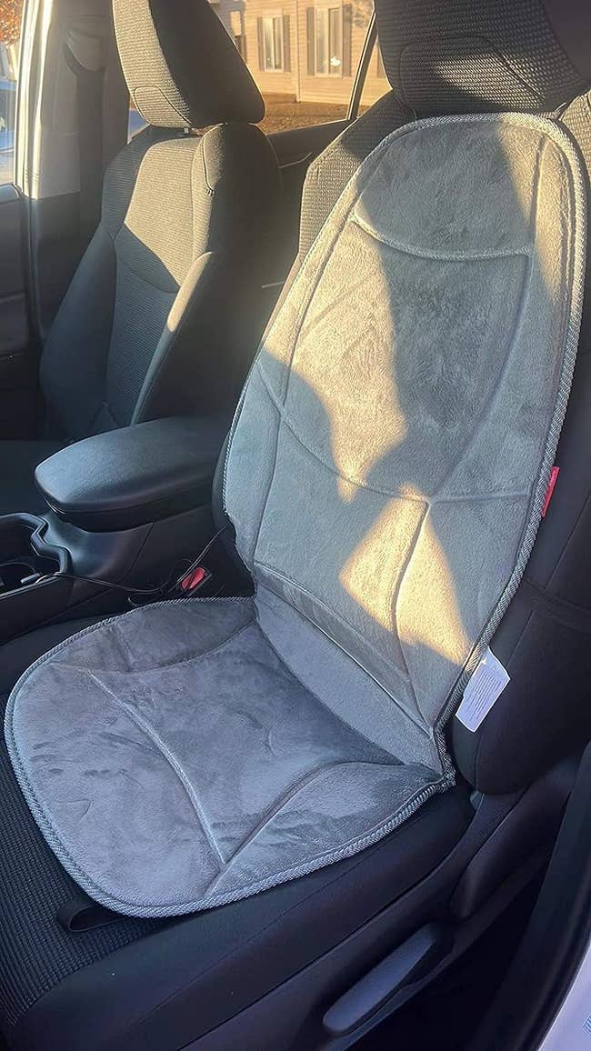 a reviewer photo of the cushion installed on the front seat of a car 