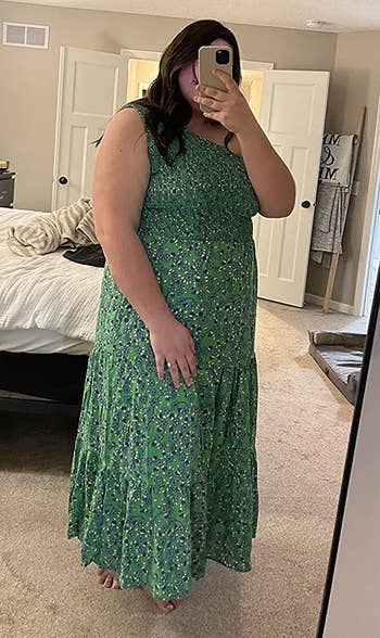 a reviewer wearing the same dress in green with a white floral print 