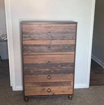 reviewer showing their distressed wood dresser with round pulls