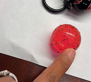 a reviewer photo of the inner sticky ball removed showing crumbs and dirt stuck to it 