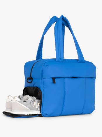 the bag with the sneaker compartment open to show how you can slide shoes inside
