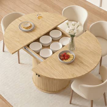 Round woody  eating  array  with hidden storage, displaying dishes and a vase with flowers, surrounded by pick  chairs